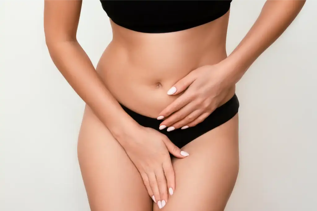 Woman holding her lower abdomen to represent intimate rejuvenation and wellness care for lichen sclerosus at Selfishly Aesthetics in San Francisco, CA.