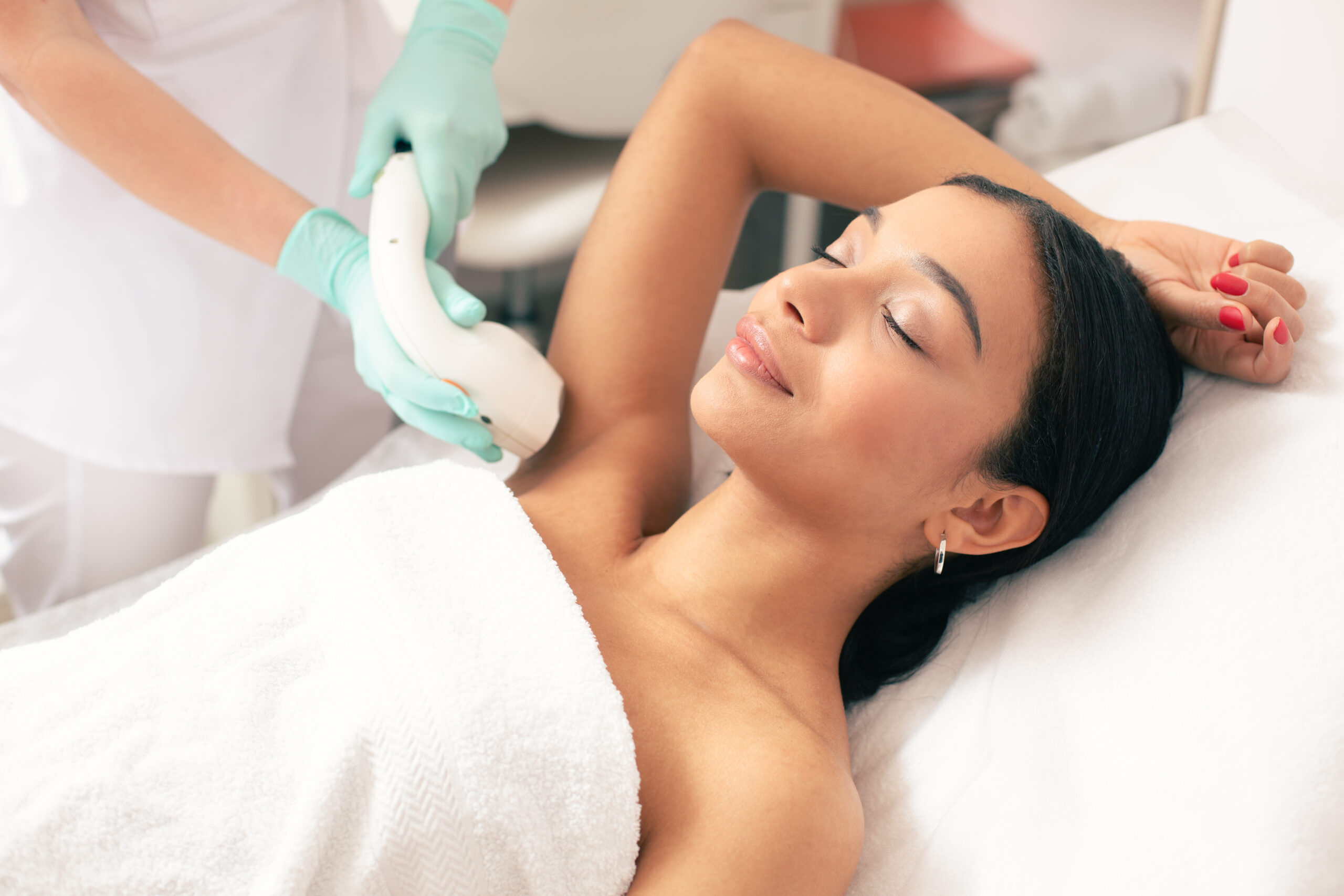 Woman receiving laser hair removal treatment under the arm at Selfishly Aesthetics & Wellness in San Francisco, CA.