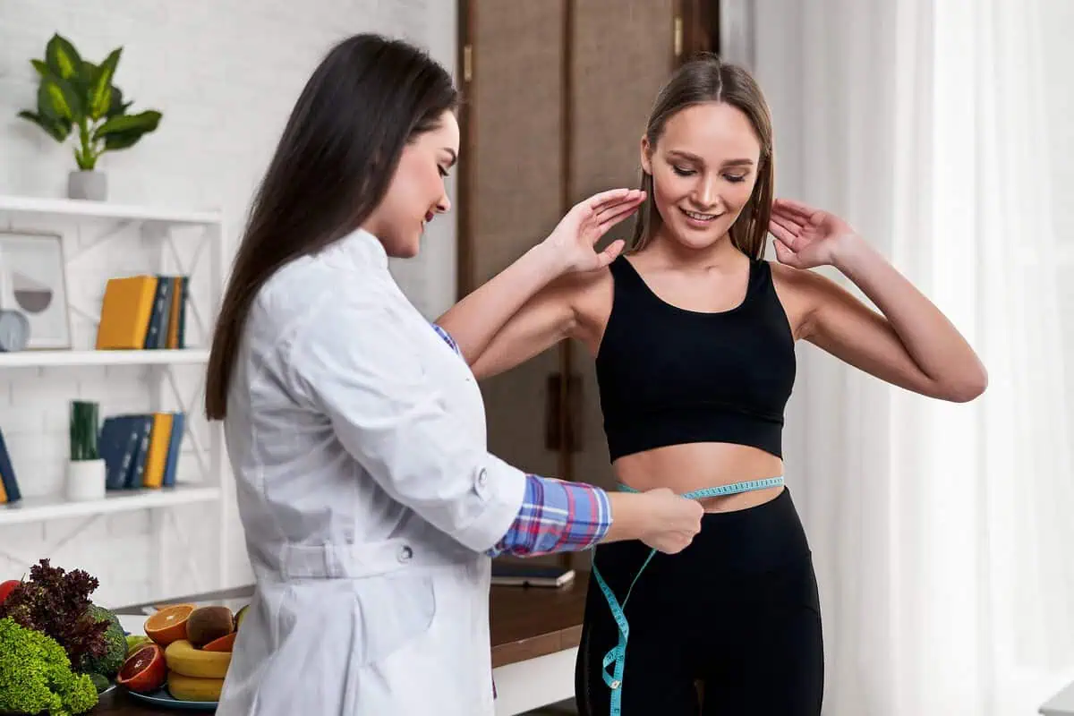 Healthcare provider measuring a patient's waist during a medically supervised GLP-1 weight loss program in San Francisco, CA.