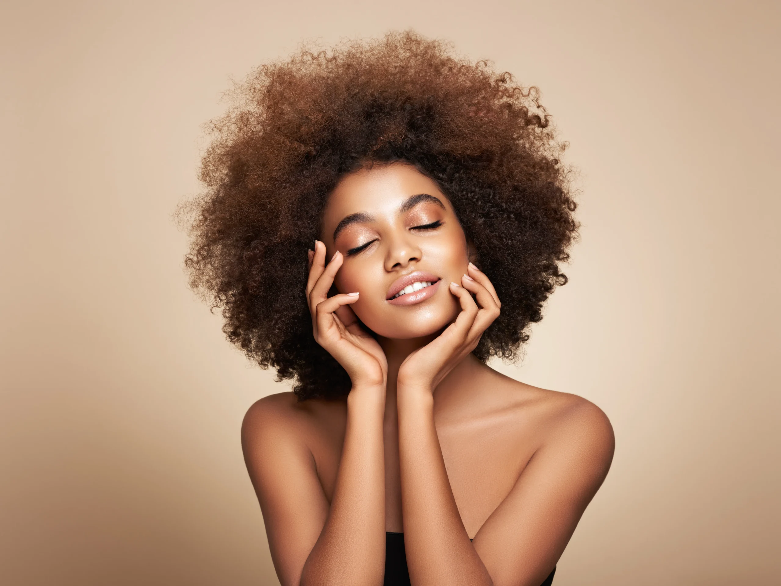 a woman with curly hair and eyes closed | Skin Deep | Selfishly Wellness in San Francisco, CA